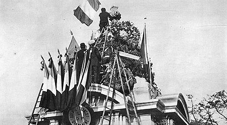 UN ALSACIEN DÉPOSE SUR LE MONUMENT DES DRAPEAUX FRANÇAIS ET BELGES